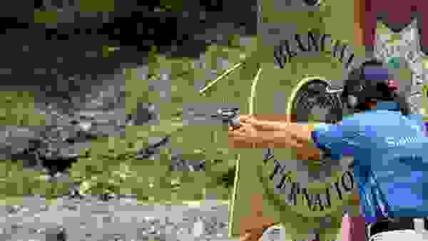 Bianchi Cup Competitor Shooting a Revolver in an Outdoor Range