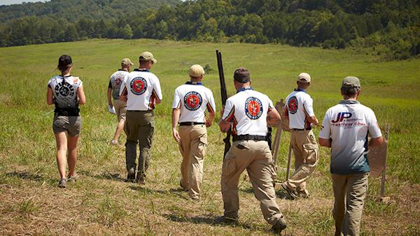 Group of NRA Shooters Approach Targets in a Field